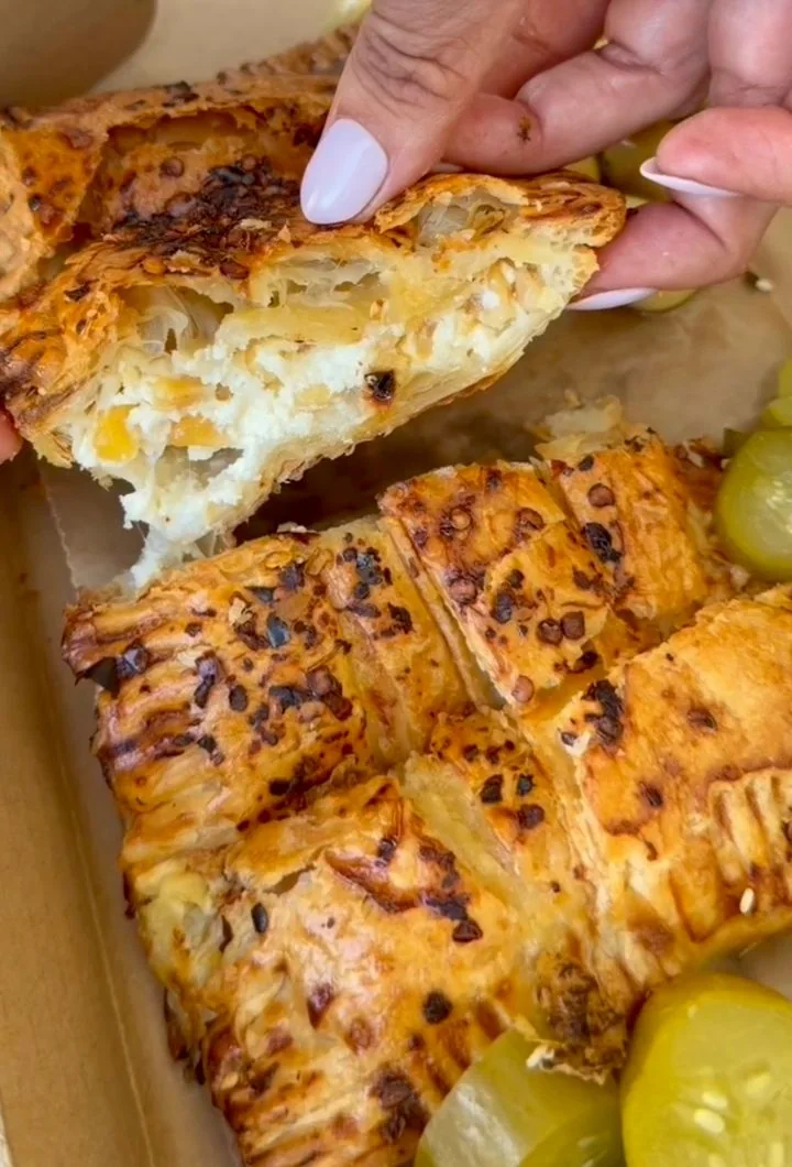 Corn and cheese burekas opened to show the filling